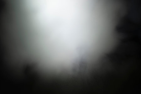 Light and shadow with white haze on a black and dark background.の写真素材