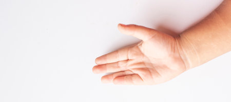 Child's hand and finger gestures on white backgroundの写真素材