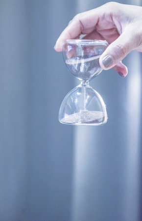picture of hand holding hourglassの写真素材