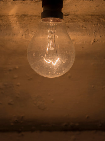 light bulb a device used to convert electricity into light, consisting of a source of illuminationの写真素材