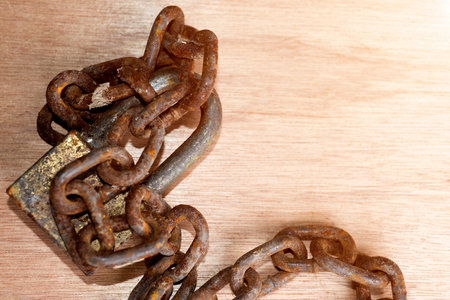 Rusty chain on wooden floorの写真素材