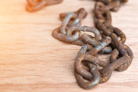 Rusty chain on wooden floorの写真素材
