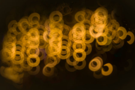 Background photography of golden yellow spherical light, striking color, black scene Abstract digital graphic patternの写真素材