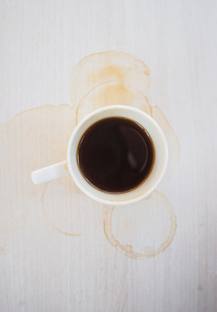 Spilled coffee cup stain on wooden floorの写真素材