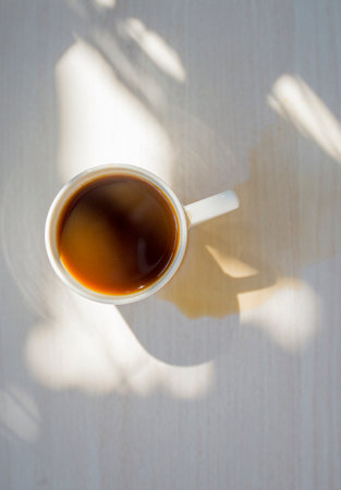 Spilled coffee cup stain on wooden floorの写真素材