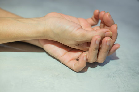 Numbness in the hands and muscle crampsの写真素材