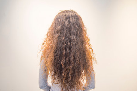 A woman's long, curly, red hair is frizzy.の写真素材