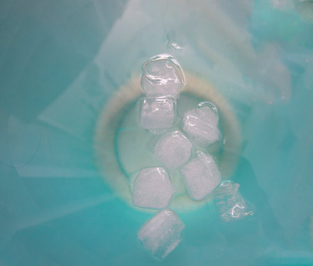 Ice cubes on the blue water surface