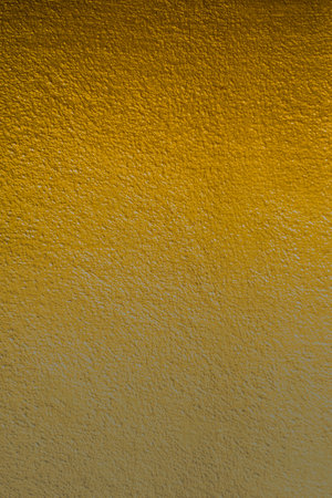 Yellow cement wall texture background.