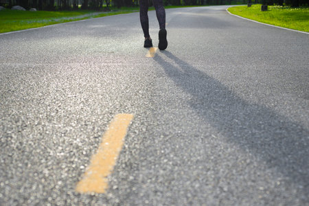 Runner feet running on the road in the park, jogging conceptの写真素材