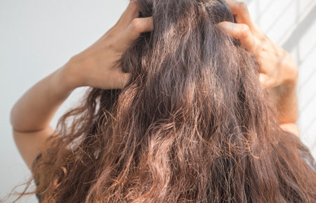 Close up of woman brushing her long brown hair in the morning.の写真素材