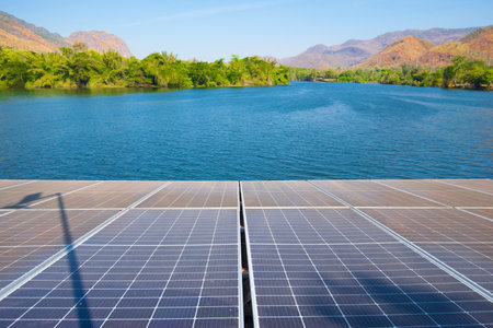 Solar panels installed on the surface of the lake with mountain background.