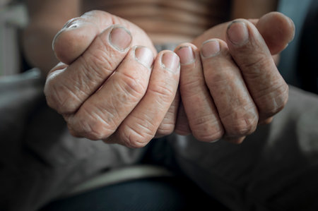 The hands of the elderly are weathered.