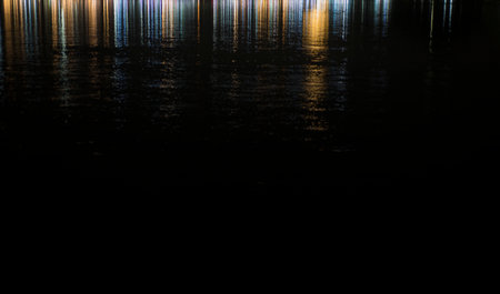 Reflection of light in the water at night. Abstract background.の写真素材