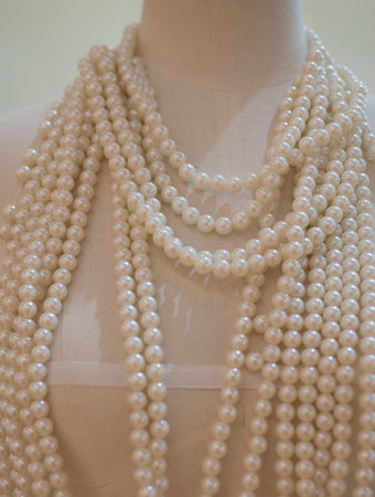Pearl necklace on a mannequin in a shop window.の写真素材