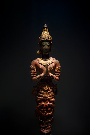 Ancient Thai style sculpture on a black background in the museum of Thailandの写真素材