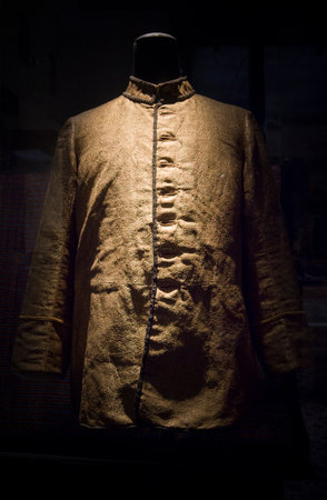 Mannequin wearing a gold jacket in a shop window of a fashion storeの写真素材