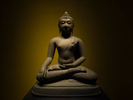 Buddha statue on a dark background, closeup of photo