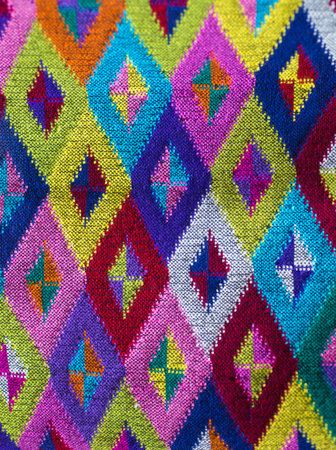 Colorful embroidery on a fabric background. Close up.