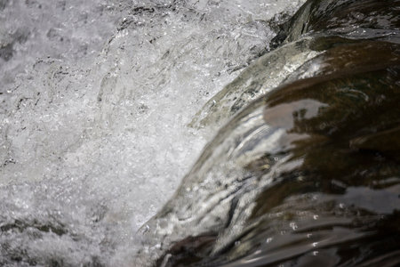 Close-up of a waterfall in the forest. Shallow depth of field