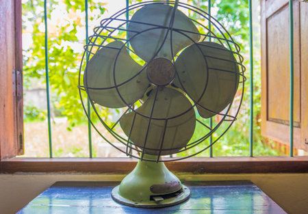 Vintage electric fan on the table in the garden, stock photoの写真素材