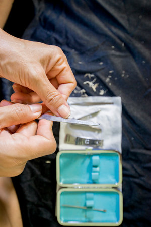Manicure process in a beauty salon, closeup of hands