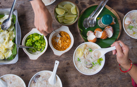 Rice porridge in a bowl on wooden background, Thailand.