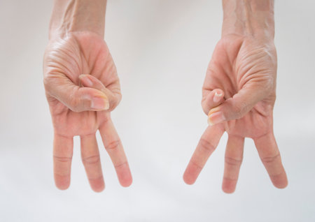 Close-up of hands showing fingers on white background with copy spaceの写真素材