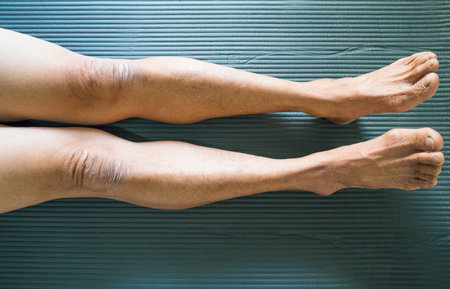 Close up of the feet of a senior woman on a blue backgroundの写真素材