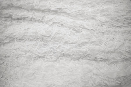 Cloth is white. This is a photograph of a crumpled fabric backgroundの写真素材