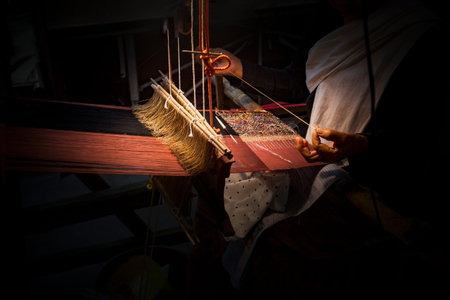 Weaving loom in the process of weaving a traditional silk fabric