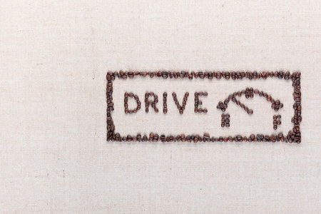 Word drive next to a fuel gauge inside a rectangle all made up from coffee beans, aligned on the right.の写真素材
