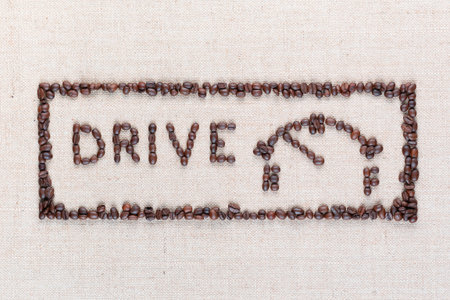 Word drive next to a fuel gauge inside a rectangle all made up from coffee beans, aligned in the center, close up.の写真素材