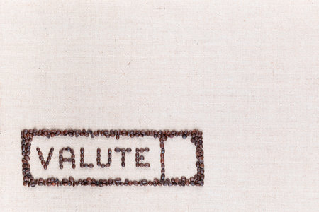 The word valute inside a rectangle written with coffee beans on creamy linea canvas, shot from above,aligned at the bottom left.の写真素材
