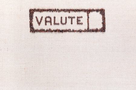 The word valute inside a rectangle written with coffee beans on creamy linea canvas, shot from above,aligned at the top.の写真素材