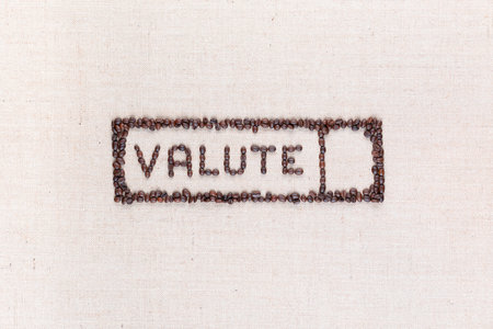 The word valute inside a rectangle written with coffee beans on creamy linea canvas, shot from above,aligned in the center.の写真素材