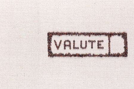 The word valute inside a rectangle written with coffee beans on creamy linea canvas, shot from above,aligned to the right.の写真素材