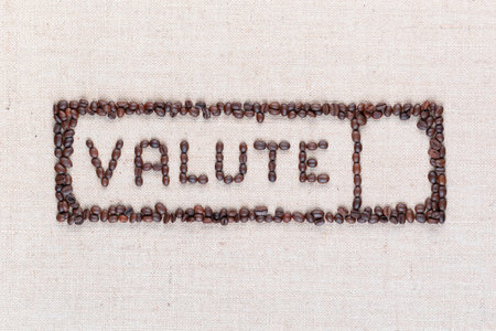 The word valute inside a rectangle written with coffee beans on creamy linea canvas, shot from above,aligned in the center,closeup.の写真素材