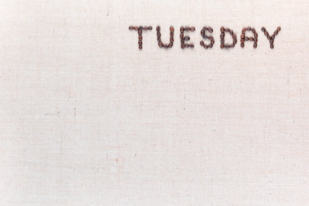 The word Thursday written with coffee beans on creamy linea canvas, shot from above , aligned at the top right.の写真素材