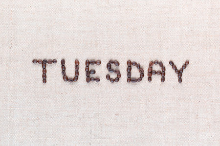 The word Thursday written with coffee beans on creamy linea canvas, shot from above , aligned in the center, closeup.の写真素材