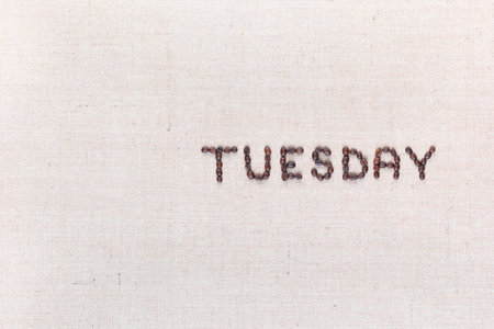 The word Thursday written with coffee beans on creamy linea canvas, shot from above , aligned to the right.の写真素材
