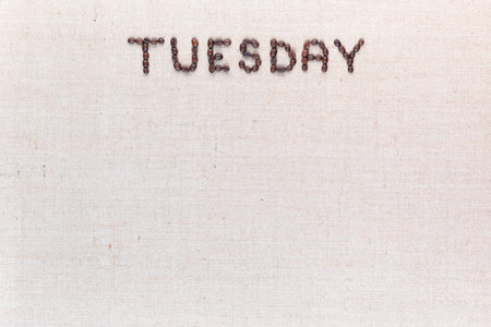 The word Thursday written with coffee beans on creamy linea canvas, shot from above , aligned at the top.の写真素材