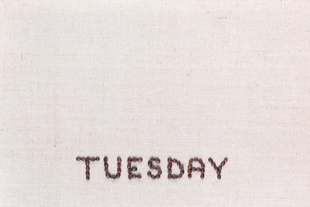 The word Thursday written with coffee beans on creamy linea canvas, shot from above , aligned at the bottom.の写真素材