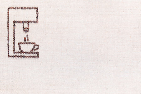 A coffee machine preparing a hot cup of coffee all made from coffee beans on creamy linea canvas, shot from above, aligned at the top left.の写真素材