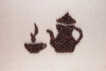 Roasted coffee beans forming steamy cup and pot on linen surface, aligned in centerの写真素材