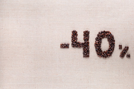 Roasted coffee beans shaping 40% off writing on creamy linen background, aligned middle rightの写真素材