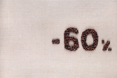 Roasted coffee beans shaping 60% off writing on creamy linen background, aligned middle rightの写真素材