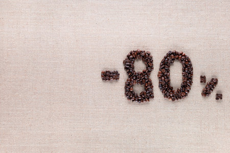 Roasted coffee beans shaping 80% off writing on creamy linen background, aligned middle rightの写真素材