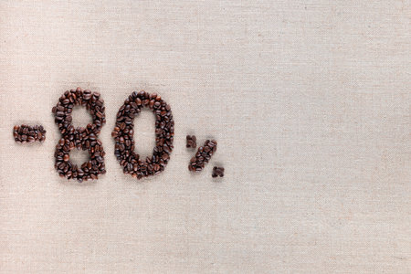Roasted coffee beans shaping 80% off writing on creamy linen background, aligned middle leftの写真素材