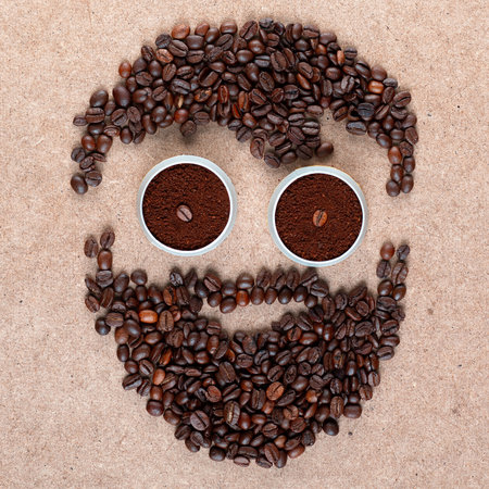 Face of bearded man and scissors made of roasted coffee beans and powder as representation of barbershop on rectangle plywood surfaceの写真素材